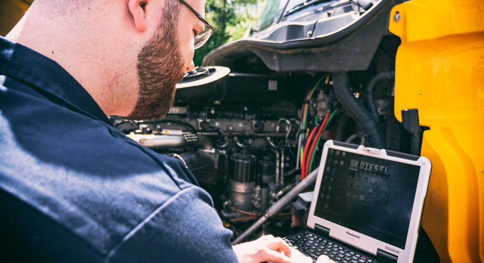 Diesel Tech diagnosing truck